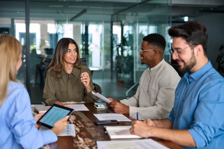 Diverse employees collaborating in a modern office, representing successful implementation of diversity, equity, and inclusion (DEI) initiatives.